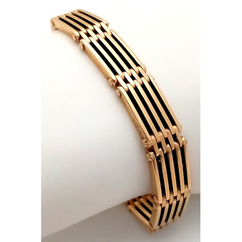 700 - A Well Constructed 9K Yellow Gold Gate Bracelet with Heart Charm and Safety Chain. 16cm. 28.75g