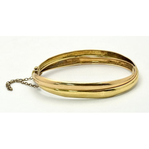 721 - A Vintage 18K Yellow Gold Bangle. Clip design. Safety chain. 15.4g.