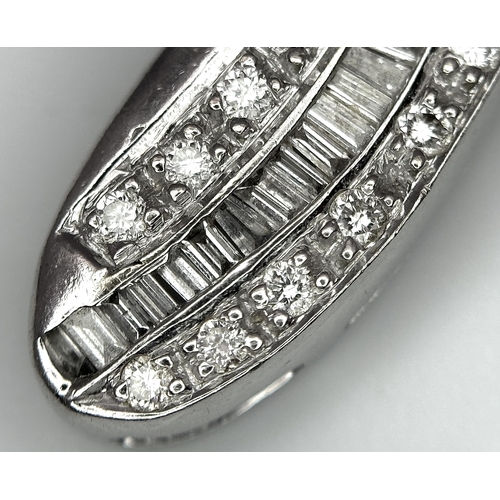 784 - A 14K White Gold Diamond Set Cross Pendant. A combination of tapered baguette, round and princess cu... 