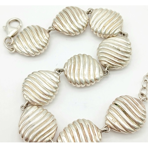 874 - A 925 Silver Bracelet - Shell Form Links. 16cm. 25g