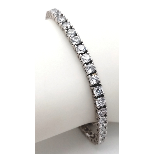 712 - A STERLING SILVER CZ SET TENNIS BRACELET. 15.5G. 16CM. 
SC5010