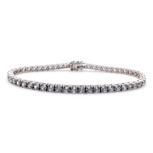 712 - A STERLING SILVER CZ SET TENNIS BRACELET. 15.5G. 16CM. 
SC5010
