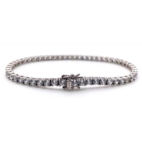 712 - A STERLING SILVER CZ SET TENNIS BRACELET. 15.5G. 16CM. 
SC5010