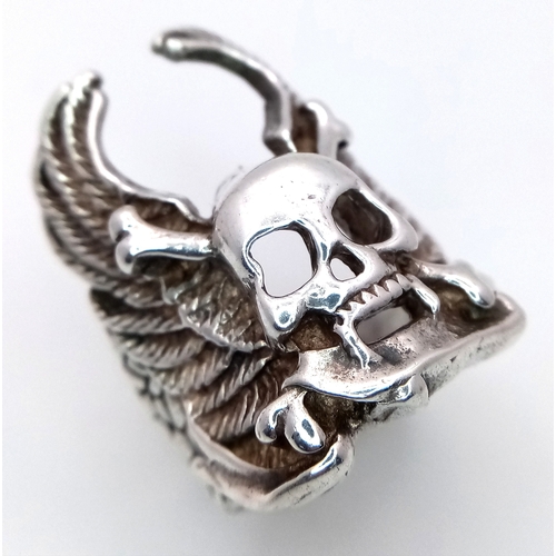 726 - A STERLING SILVER SKULL, CROSSBONES AND WINGS RING. 12.3G. SIZE S. SC5012.