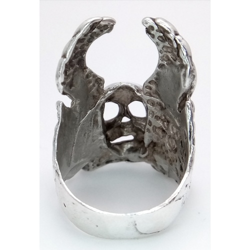 726 - A STERLING SILVER SKULL, CROSSBONES AND WINGS RING. 12.3G. SIZE S. SC5012.