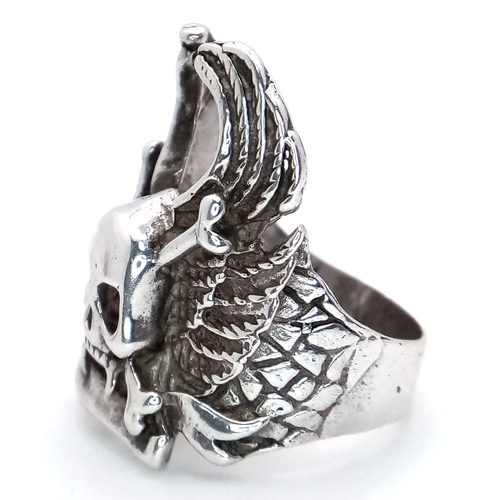 726 - A STERLING SILVER SKULL, CROSSBONES AND WINGS RING. 12.3G. SIZE S. SC5012.