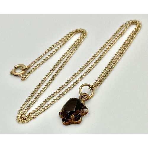 757 - A 9k yellow gold smoky quartz necklace - 8x6mm stone size. 1.9g total weight. 14” chain length. 577I