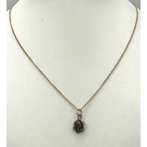 757 - A 9k yellow gold smoky quartz necklace - 8x6mm stone size. 1.9g total weight. 14” chain length. 577I
