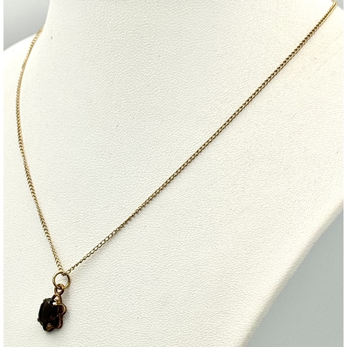 757 - A 9k yellow gold smoky quartz necklace - 8x6mm stone size. 1.9g total weight. 14” chain length. 577I