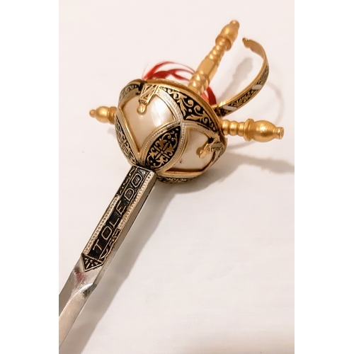 779 - A miniature Toledo sword letter opener. Length: 25cm