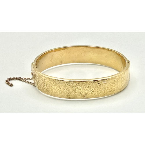 1212 - A Vintage 9K Yellow Gold Bangle. 14mm width. Chester hallmarks. A few dents and minor discolouration... 
