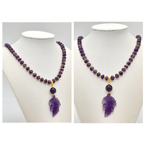 206 - An amethyst necklace and earrings set with exquisitely hand carved leaf pendants, in a presentation ... 