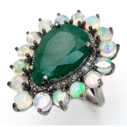 233 - A 6Ct Pear Cut Emerald Ring with a 0.20ctw Diamond and 2ctw of Opal surround. Size O. With case. Cd-... 