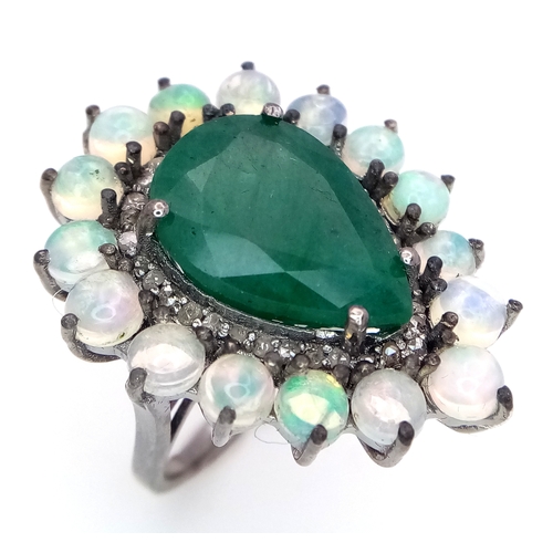 233 - A 6Ct Pear Cut Emerald Ring with a 0.20ctw Diamond and 2ctw of Opal surround. Size O. With case. Cd-... 