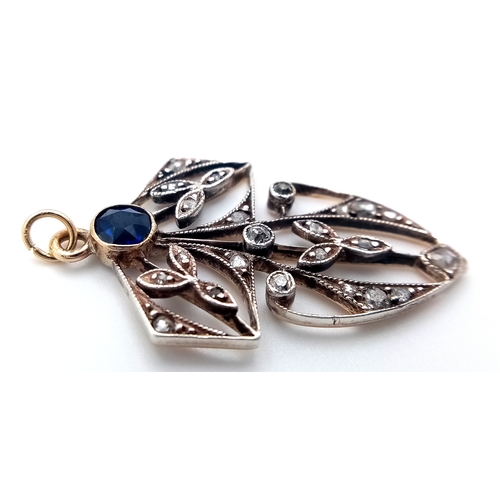 225 - A 9k yellow gold with silver diamond and sapphire pendant. 0.12ct diamond weight. 0.34ct sapphire we... 