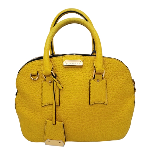 187 - A Burberry Yellow Leather Dome Tote Bag. Yellow leather exterior with gold-toned hardware, dual roll... 