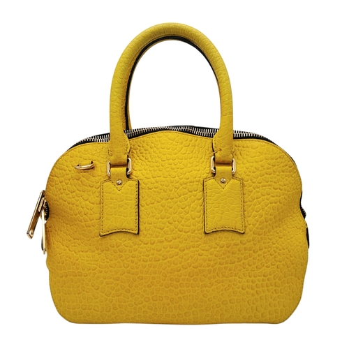 187 - A Burberry Yellow Leather Dome Tote Bag. Yellow leather exterior with gold-toned hardware, dual roll... 