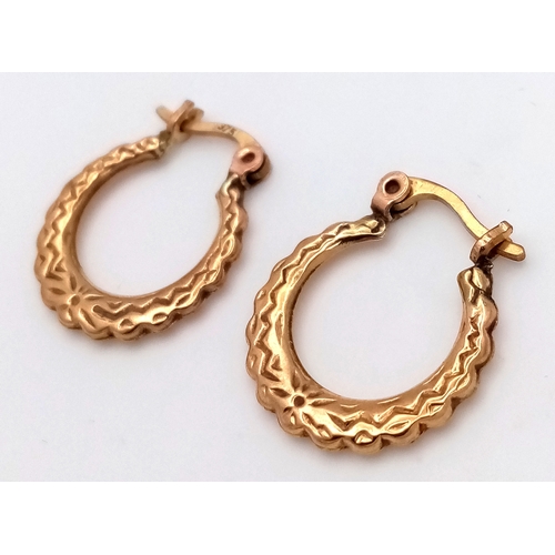 217 - Beautiful pair of 9 CARAT GOLD HOOP EARRINGS. Patterned decoration to both sides. 0.79 grams.
