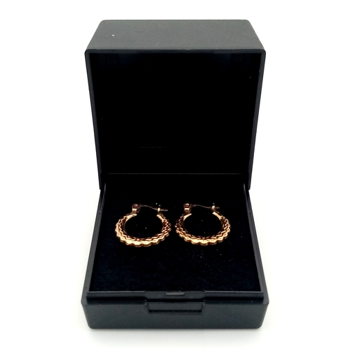 217 - Beautiful pair of 9 CARAT GOLD HOOP EARRINGS. Patterned decoration to both sides. 0.79 grams.