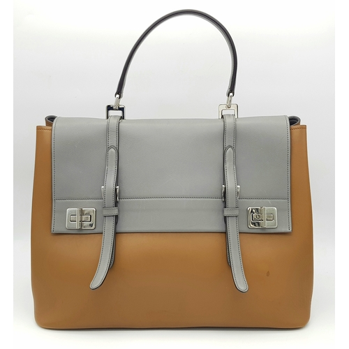 229 - A Prada Milano Two-Tone Leather Tote Bag. Grey and tan smooth leather exterior with silver-toned har... 