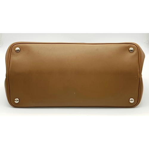 229 - A Prada Milano Two-Tone Leather Tote Bag. Grey and tan smooth leather exterior with silver-toned har... 
