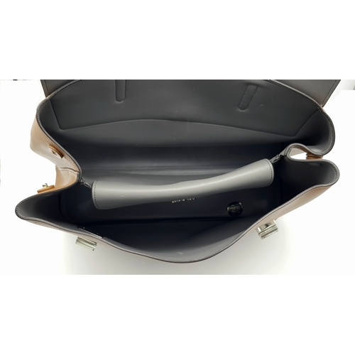 229 - A Prada Milano Two-Tone Leather Tote Bag. Grey and tan smooth leather exterior with silver-toned har... 