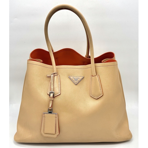 201 - A Prada Beige and Orange Leather Tote Bag. Beige leather exterior with gold-toned hardware, dual rol... 