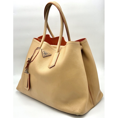 201 - A Prada Beige and Orange Leather Tote Bag. Beige leather exterior with gold-toned hardware, dual rol... 