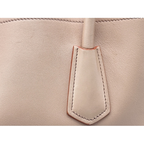 201 - A Prada Beige and Orange Leather Tote Bag. Beige leather exterior with gold-toned hardware, dual rol... 