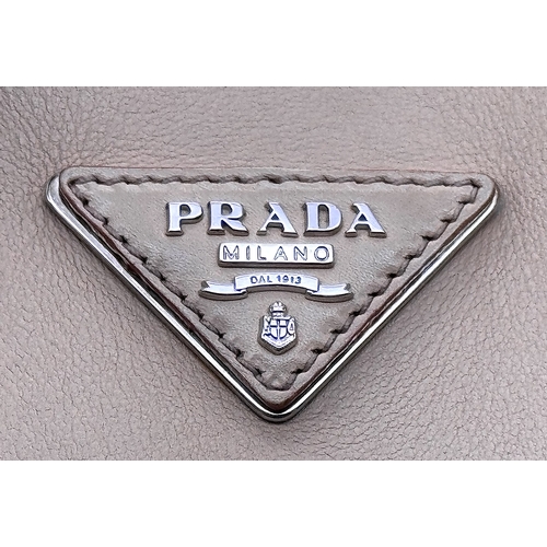 201 - A Prada Beige and Orange Leather Tote Bag. Beige leather exterior with gold-toned hardware, dual rol... 