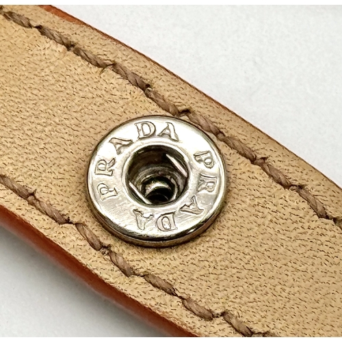 201 - A Prada Beige and Orange Leather Tote Bag. Beige leather exterior with gold-toned hardware, dual rol... 