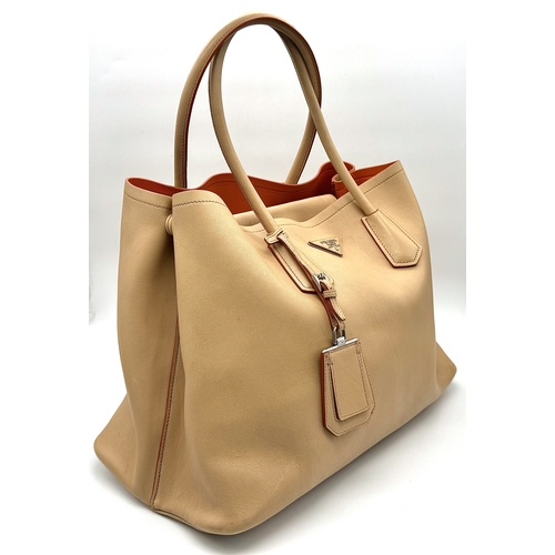 201 - A Prada Beige and Orange Leather Tote Bag. Beige leather exterior with gold-toned hardware, dual rol... 