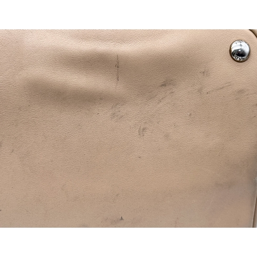 201 - A Prada Beige and Orange Leather Tote Bag. Beige leather exterior with gold-toned hardware, dual rol... 