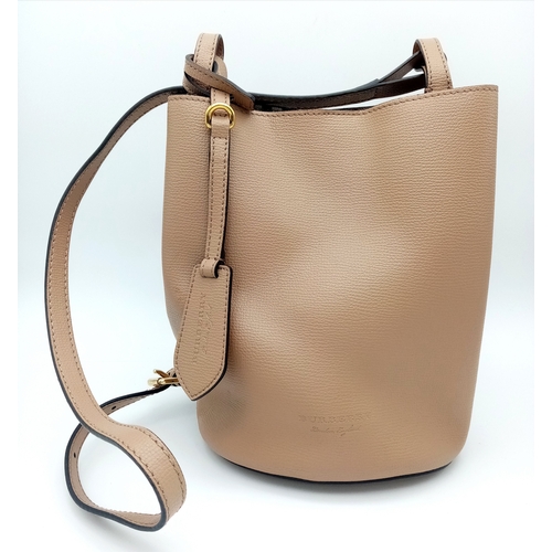 222 - A Burberry Brown Leather Bucket Bag. Brown leather exterior with gold-toned hardware and an adjustab... 