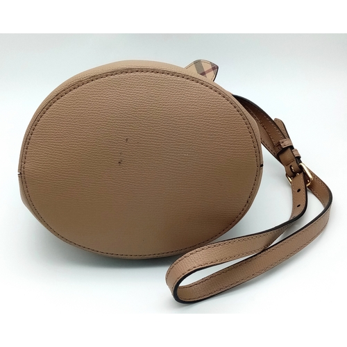 222 - A Burberry Brown Leather Bucket Bag. Brown leather exterior with gold-toned hardware and an adjustab... 