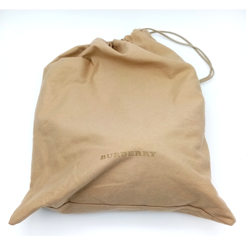222 - A Burberry Brown Leather Bucket Bag. Brown leather exterior with gold-toned hardware and an adjustab... 
