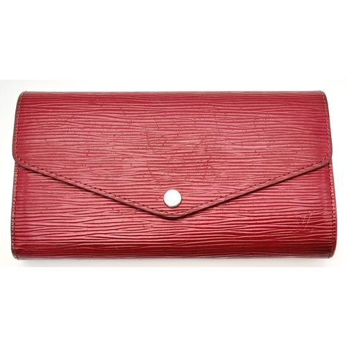 194 - A Louis Vuitton Epi Sarah Wallet. Purple Epi leather exterior with silver-toned hardware and a patch... 