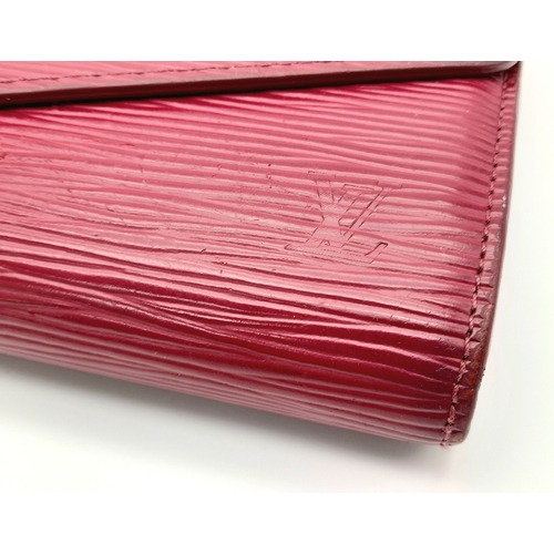 194 - A Louis Vuitton Epi Sarah Wallet. Purple Epi leather exterior with silver-toned hardware and a patch... 