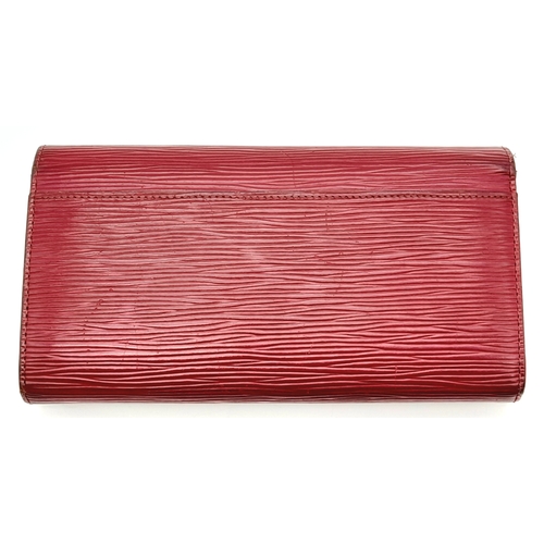 194 - A Louis Vuitton Epi Sarah Wallet. Purple Epi leather exterior with silver-toned hardware and a patch... 