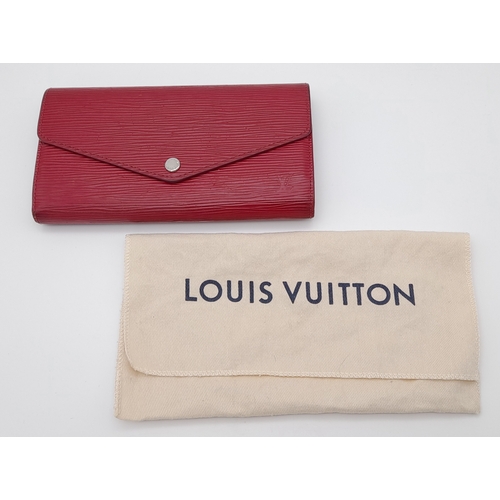 194 - A Louis Vuitton Epi Sarah Wallet. Purple Epi leather exterior with silver-toned hardware and a patch... 