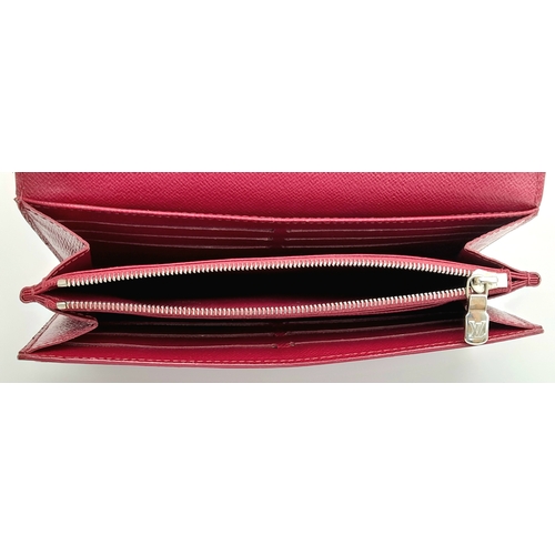 194 - A Louis Vuitton Epi Sarah Wallet. Purple Epi leather exterior with silver-toned hardware and a patch... 