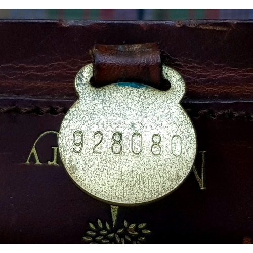 236 - A Mulberry Black Heritage Travel Suitcase. Leather exterior with gold-toned hardware, two zipped com... 