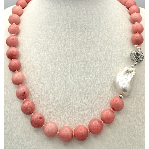 346 - A Pink Rhodochrosite and Baroque Pearl Necklace. 12mm beads. Glitterball clasp. 48cm necklace length... 