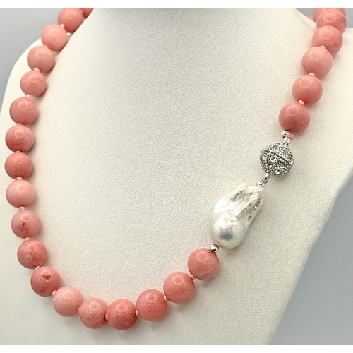 346 - A Pink Rhodochrosite and Baroque Pearl Necklace. 12mm beads. Glitterball clasp. 48cm necklace length... 