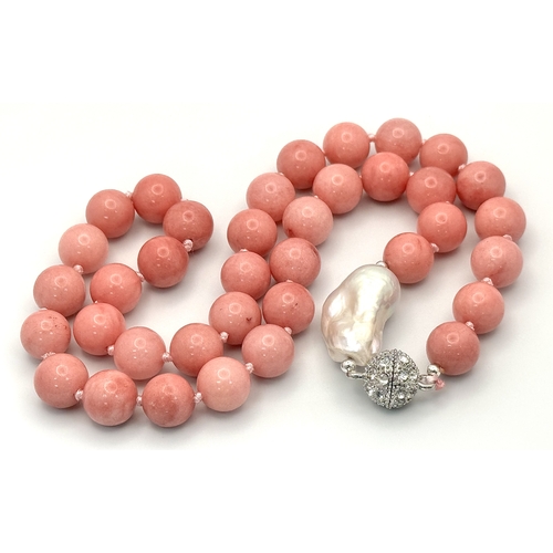 346 - A Pink Rhodochrosite and Baroque Pearl Necklace. 12mm beads. Glitterball clasp. 48cm necklace length... 