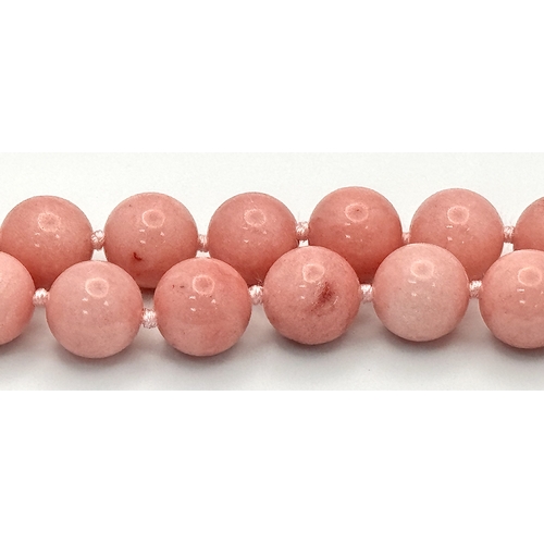 346 - A Pink Rhodochrosite and Baroque Pearl Necklace. 12mm beads. Glitterball clasp. 48cm necklace length... 
