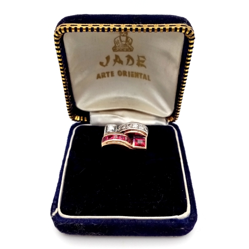 48 - An 18K Gold, Ruby and Diamond Ring. Princess and round cut stones in a mirrored form. 0.40ctw diamon... 