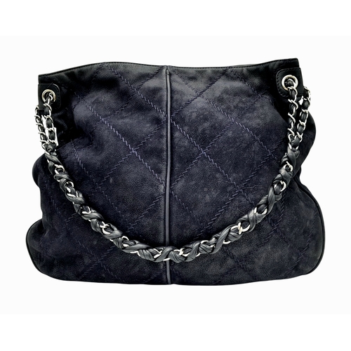 54 - A Chanel Dark Blue Tote Bag. Quilted leather exterior with silver-toned hardware, single chain and l... 