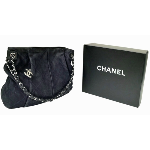 54 - A Chanel Dark Blue Tote Bag. Quilted leather exterior with silver-toned hardware, single chain and l... 
