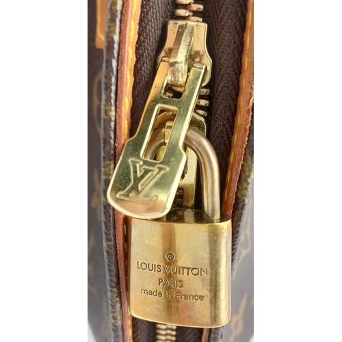 124 - A Louis Vuitton Monogram Ellipse Bag. Coated canvas exterior with leather trim, gold-toned hardware,... 